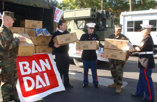 CYPRESS, Calif., Dec. 18, 2002 - Brightening the holidays for thousands of disadvantaged families this holiday season, volunteers from the U.S. Marine Corps assist Bill Beebe, senior vice president of sales and marketing at Bandai America Inc., in unloading a tractor-trailer of toys being delivered to the Salvation Army.  Bandai America announced the donation of more than $5.8 million worth of toys to the 2002 U.S. Marine Corps Reserve Toys for Tots Campaign - the largest donation from a toy company in the country.  A national corporate sponsor of Toys for Tots since 1995, Bandai more than doubled its donation from last year.